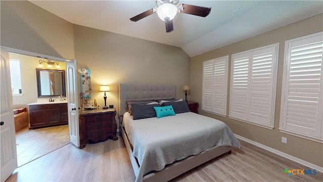 bedroom with lofted ceiling, sink, ceiling fan, connected bathroom, and light hardwood / wood-style floors