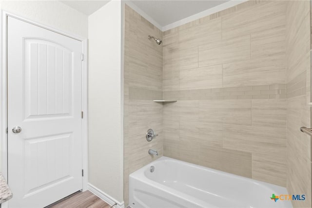 full bathroom with shower / bath combination, baseboards, and wood finished floors