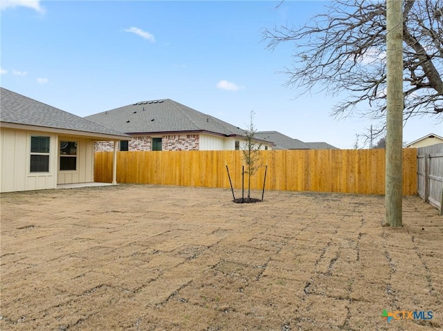 view of yard with a fenced backyard