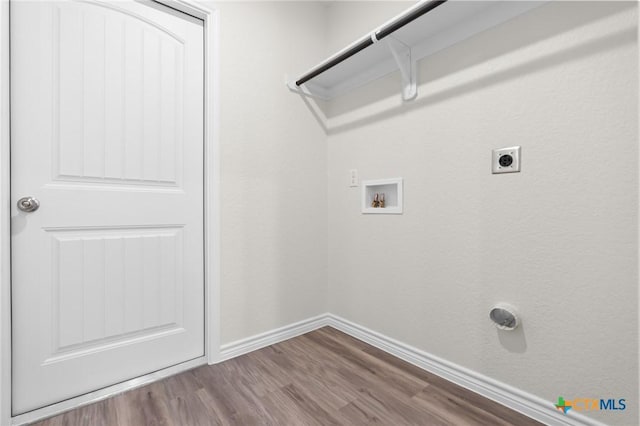 laundry area with laundry area, baseboards, wood finished floors, hookup for a washing machine, and hookup for an electric dryer