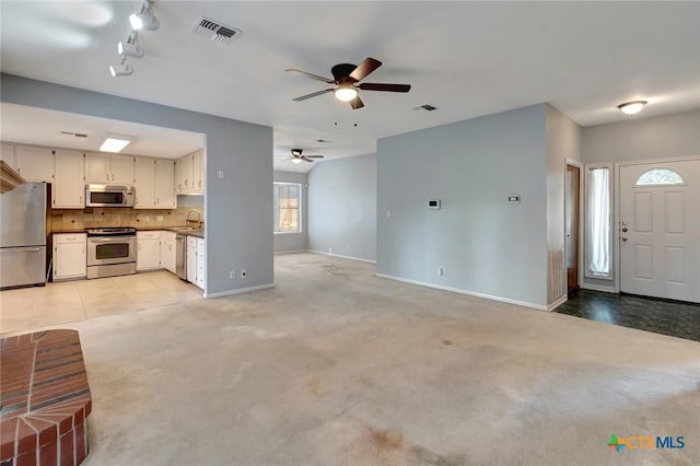 218 Sunset Dr, Victoria, TX 77901 - unfurnished living room with ceiling fan, light carpet, and track lighting