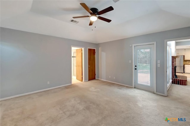 218 Sunset Dr, Victoria, TX 77901 - unfurnished bedroom featuring access to exterior, carpet, freestanding refrigerator, a ceiling fan, and ensuite bath