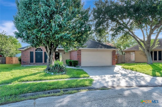 218 Sunset Dr, Victoria, TX 77901 - view of front of home featuring driveway, brick siding, and a garage