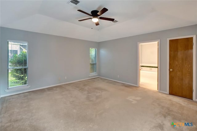 218 Sunset Dr, Victoria, TX 77901 - unfurnished bedroom with light carpet, ensuite bath, and a ceiling fan
