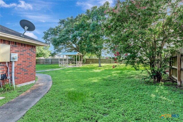 218 Sunset Dr, Victoria, TX 77901 - fenced backyard with a gazebo