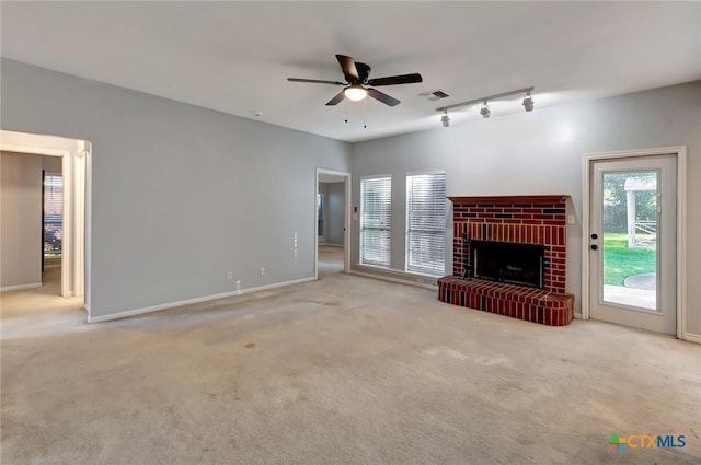 218 Sunset Dr, Victoria, TX 77901 - unfurnished living room with a ceiling fan, carpet, a fireplace, and rail lighting