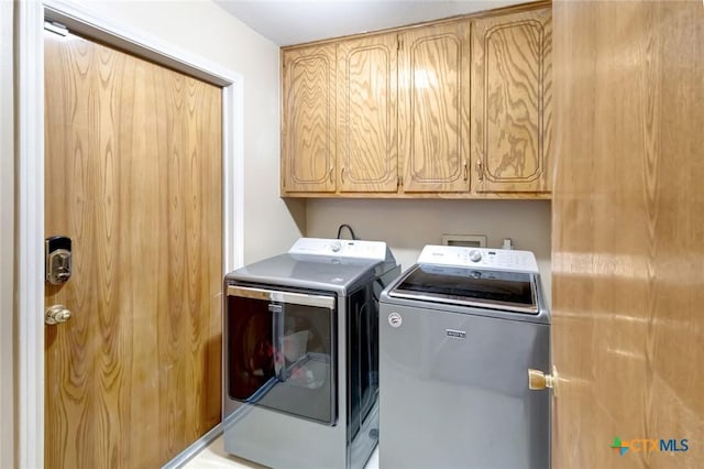 218 Sunset Dr, Victoria, TX 77901 - laundry room featuring independent washer and dryer and cabinet space