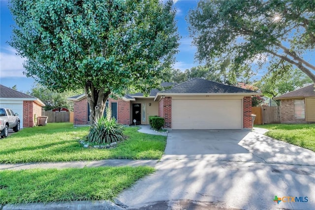 218 Sunset Dr, Victoria, TX 77901 - ranch-style home featuring concrete driveway, a garage, and brick siding