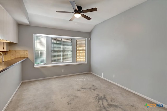 218 Sunset Dr, Victoria, TX 77901 - unfurnished dining area with ceiling fan, light colored carpet, and vaulted ceiling