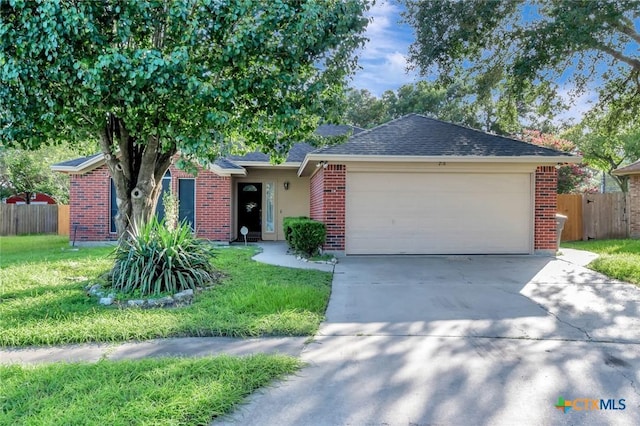 218 Sunset Dr, Victoria, TX 77901 - single story home with brick siding, concrete driveway, a garage, and a shingled roof