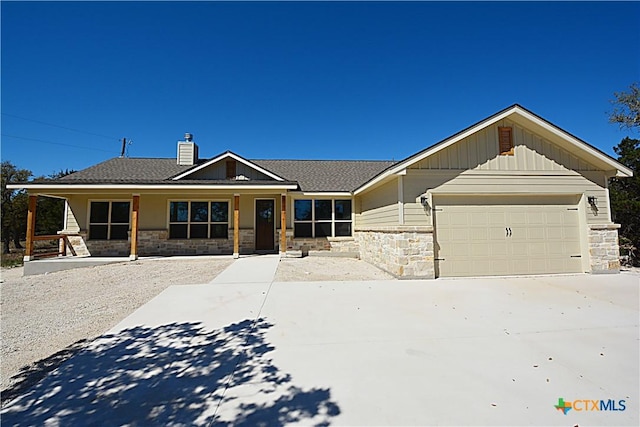 1598 Desiree St, Canyon Lake, TX 78133 - craftsman-style home featuring board and batten siding, a garage, stone siding, and driveway