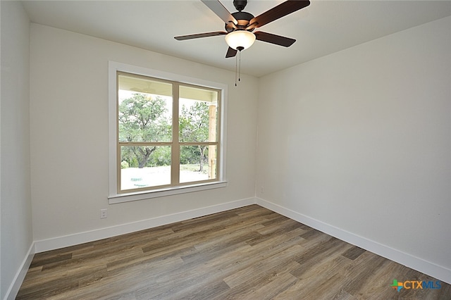 spare room with hardwood / wood-style floors and ceiling fan