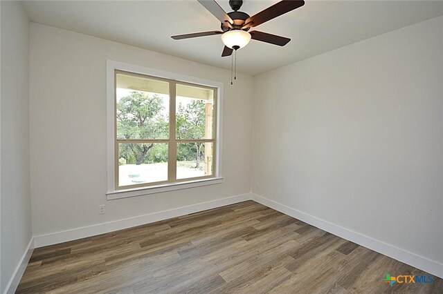 1598 Desiree St, Canyon Lake, TX 78133 - unfurnished room with wood finished floors, baseboards, and ceiling fan