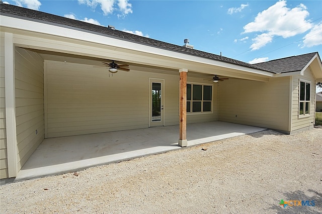 back of property with ceiling fan and a patio