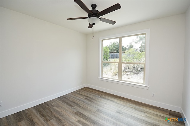 spare room with ceiling fan and wood-type flooring