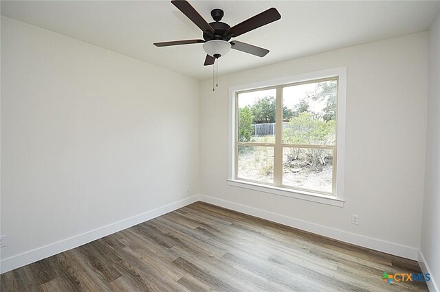 1598 Desiree St, Canyon Lake, TX 78133 - spare room with dark wood-style floors, baseboards, and ceiling fan