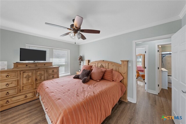 bedroom featuring ornamental molding, ensuite bath, dark wood-type flooring, and ceiling fan