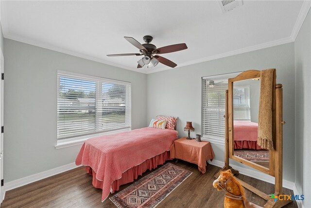 bedroom with ornamental molding, dark hardwood / wood-style floors, and ceiling fan