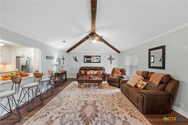 living room with ornamental molding, lofted ceiling with beams, and dark hardwood / wood-style floors