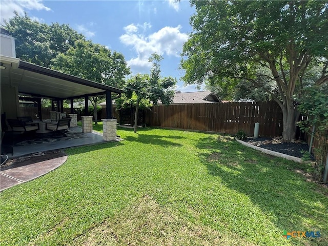 view of yard featuring a patio, an outdoor hangout area, and a fenced backyard