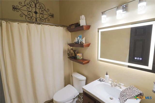 bathroom with toilet and vanity