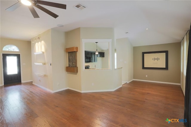 unfurnished living room featuring wood finished floors, baseboards, visible vents, a ceiling fan, and lofted ceiling