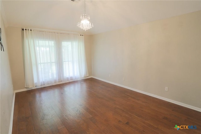 unfurnished room featuring a chandelier, baseboards, and dark wood-style floors