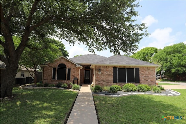 view of front of house featuring a front yard and brick siding