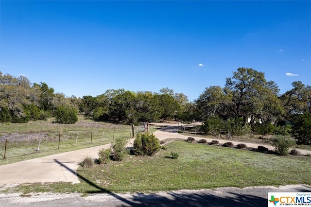 view of home's community featuring a rural view and a yard