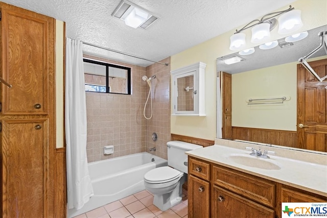 full bathroom with toilet, tile patterned flooring, a textured ceiling, vanity, and shower / bathtub combination with curtain