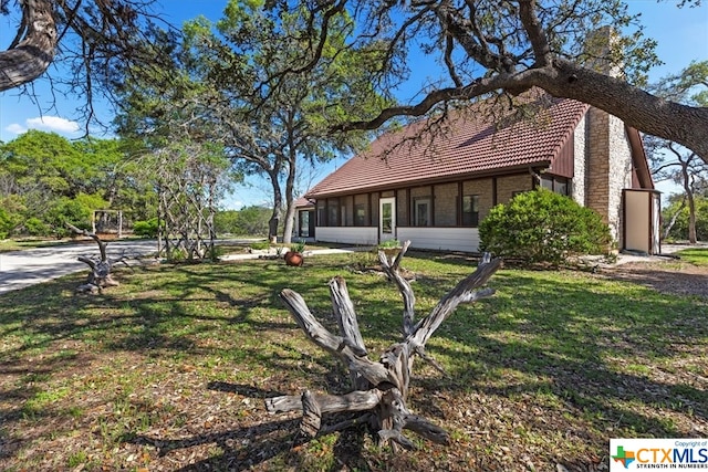 exterior space with a lawn and a sunroom