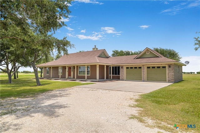 99 N Seakist Ln, Port Lavaca, TX 77979 - single story home with driveway, an attached garage, a front lawn, a chimney, and covered porch