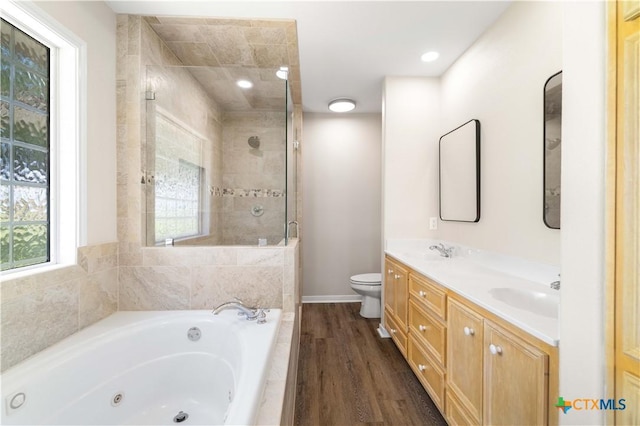 99 N Seakist Ln, Port Lavaca, TX 77979 - bathroom with a jetted tub, double vanity, tiled shower, and wood finished floors