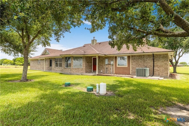 99 N Seakist Ln, Port Lavaca, TX 77979 - view of front facade with a front yard, brick siding, and a chimney