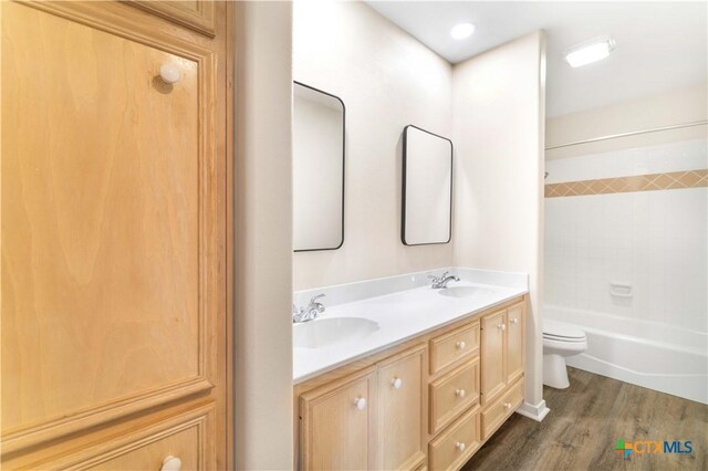 99 N Seakist Ln, Port Lavaca, TX 77979 - full bathroom featuring double vanity, wood finished floors, and tub / shower combination
