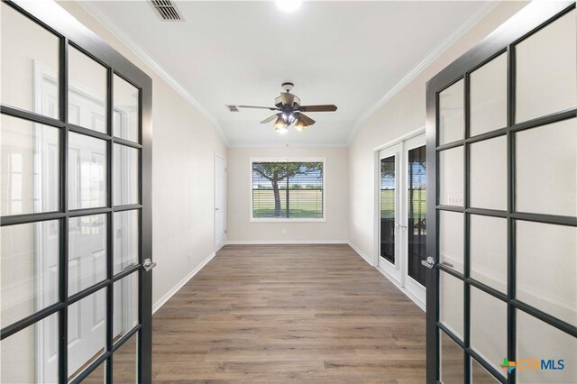99 N Seakist Ln, Port Lavaca, TX 77979 - empty room featuring french doors, crown molding, wood finished floors, and a ceiling fan