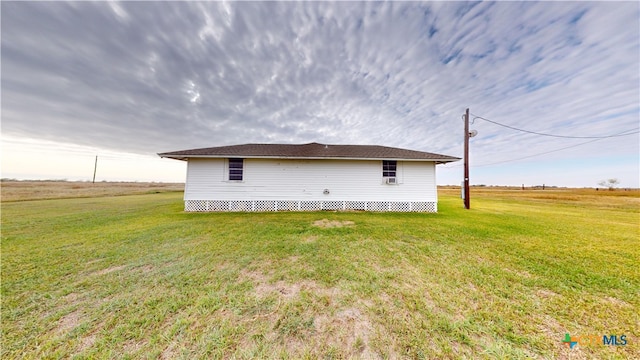 back of property featuring a yard