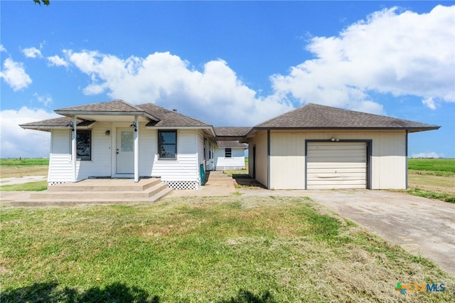 single story home with a front yard and a garage