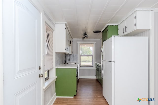 kitchen featuring hardwood / wood-style flooring, sink, white cabinets, and white refrigerator