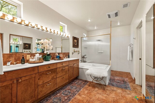10329 Montanio Dr, New Braunfels, TX 78132 - full bath with a shower with shower door, a bath, double vanity, backsplash, and recessed lighting