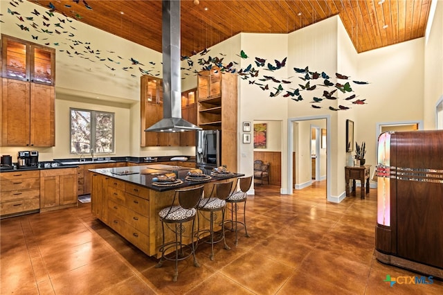10329 Montanio Dr, New Braunfels, TX 78132 - kitchen with wooden ceiling, a high ceiling, dark countertops, range hood, and fridge with ice dispenser