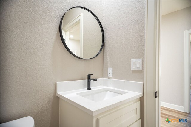 bathroom with vanity and hardwood / wood-style flooring