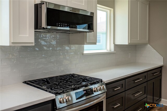 kitchen featuring stainless steel appliances, white cabinets, and a healthy amount of sunlight