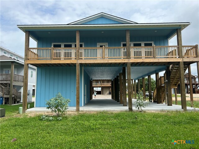 rear view of house with central AC unit and a yard