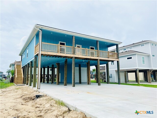 back of property with a carport