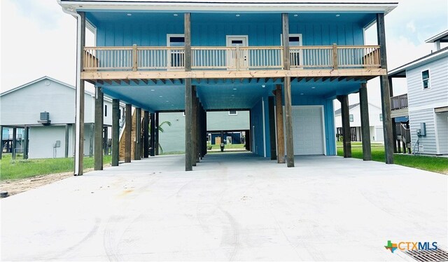 coastal home featuring a garage and a carport