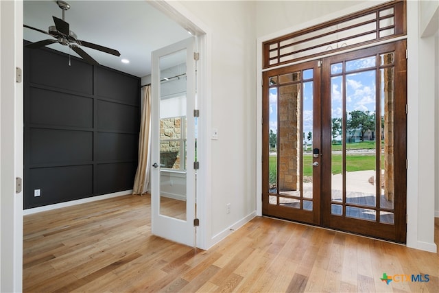 foyer with french doors, light hardwood / wood-style floors, ceiling fan, and plenty of natural light