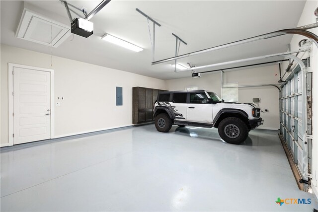 garage featuring a garage door opener and electric panel