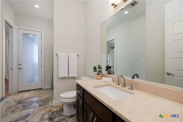 bathroom with vanity and toilet