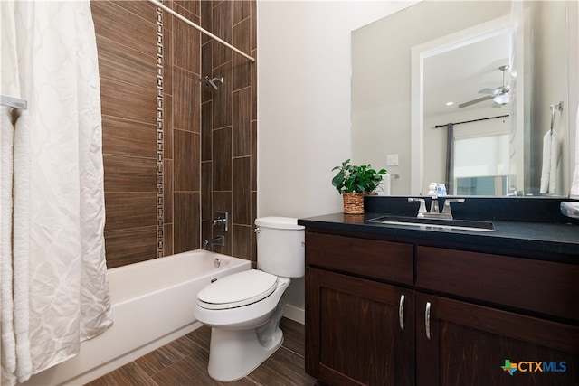 full bathroom featuring vanity, shower / bath combination with curtain, toilet, and ceiling fan